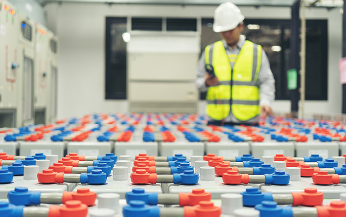 Engineer inspecting industrial batteries